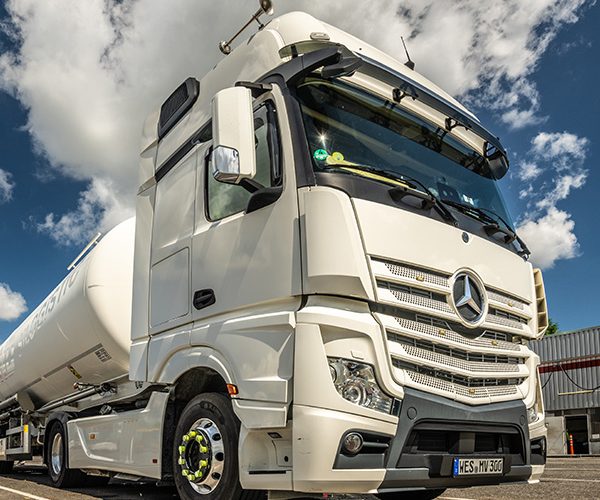 Weißer Mercedes-Siloauflieger für Logistiktransporte auf dem Betriebshof von Verhuven.